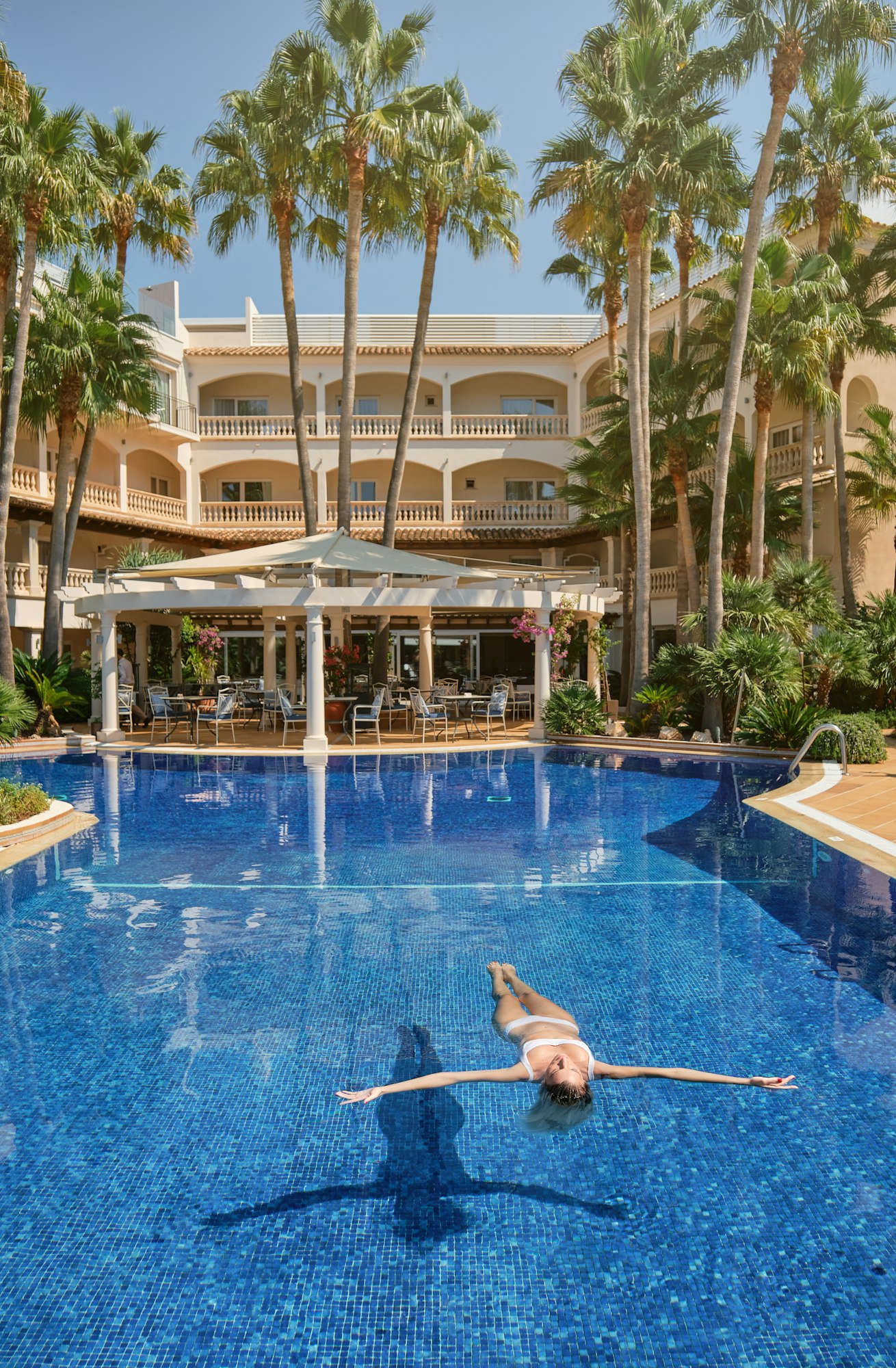 Woman swimming in clean pool in hotel